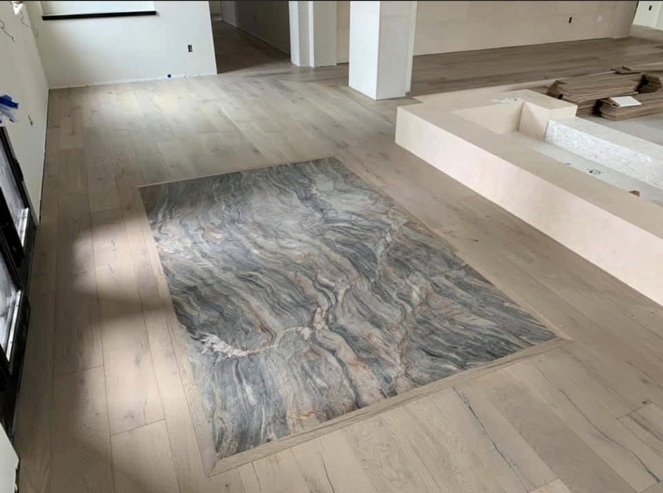 Custom white oak flooring with stone inlay