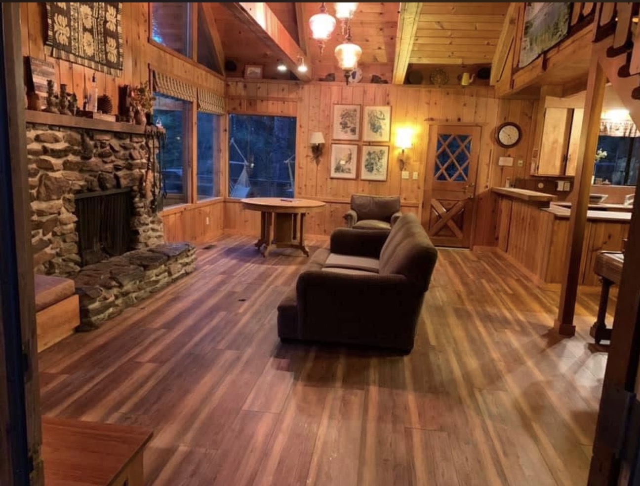 Hardwood flooring cabin living room stone fireplace